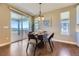 Cozy dining area with hardwood floors, sliding glass doors, and stylish lighting at 6614 Club Villa Rd, Parker, CO 80134