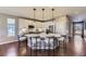 Bright kitchen with white cabinetry, stainless steel appliances, and bar seating at the island at 6614 Club Villa Rd, Parker, CO 80134
