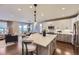 Open-concept kitchen featuring an island, modern appliances, and sleek countertops at 6614 Club Villa Rd, Parker, CO 80134