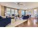 Bright living room featuring hardwood floors, large windows, and stylish furnishings at 6614 Club Villa Rd, Parker, CO 80134