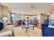 Open concept living room and kitchen with hardwood floors, modern lighting, and stainless steel appliances at 6614 Club Villa Rd, Parker, CO 80134