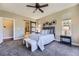 Spacious main bedroom with ensuite bathroom, ceiling fan and natural light at 6614 Club Villa Rd, Parker, CO 80134