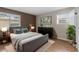 Comfortable bedroom with a plush bed, natural light, and ample closet space at 8555 Fairmount Dr # D204, Denver, CO 80247