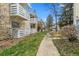 View of well-maintained condo units with balconies, landscaping, and walkway at 8555 Fairmount Dr # D204, Denver, CO 80247