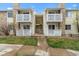 Exterior of condo buildings featuring balconies, stone accents, and well-kept grounds at 8555 Fairmount Dr # D204, Denver, CO 80247