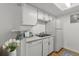 Bright kitchen with white cabinets, modern appliances, and a functional layout at 8555 Fairmount Dr # D204, Denver, CO 80247