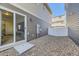 Backyard view showing a clean gravel area and the back of the home at 18270 E 51St Pl, Denver, CO 80249