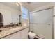 Clean bathroom featuring a granite countertop, a large mirror, and a glass-enclosed shower at 18270 E 51St Pl, Denver, CO 80249