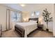 Inviting bedroom with neutral tones, a large window, and a comfortable queen-sized bed at 18270 E 51St Pl, Denver, CO 80249