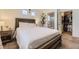 Bright bedroom with a queen bed, bedside tables, and an en-suite bathroom with a walk-in closet at 18270 E 51St Pl, Denver, CO 80249