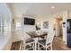 Open dining area featuring stylish wood floors, a modern table set, and plenty of natural light at 18270 E 51St Pl, Denver, CO 80249