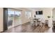 Dining area featuring a table with four chairs, a view through the sliding glass door, and modern luxury vinyl flooring at 18270 E 51St Pl, Denver, CO 80249