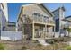 Charming home featuring a second story balcony, neat front yard with stone ground cover, and concrete steps leading to the front door at 18270 E 51St Pl, Denver, CO 80249