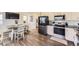 Modern kitchen featuring stainless steel appliances, white cabinets, and an open dining area at 18270 E 51St Pl, Denver, CO 80249