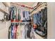 Organized walk-in closet filled with clothing, shelving, and storage solutions for optimal space at 18270 E 51St Pl, Denver, CO 80249