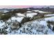 Scenic aerial view of a vast snow-covered mountain landscape with home and trees at 118 Gold Piece Dr, Breckenridge, CO 80424