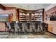 Custom wet bar features beautiful cabinetry, stone accents, and seating for five at 118 Gold Piece Dr, Breckenridge, CO 80424