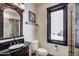 Bathroom with dark wood vanity, white toilet, and window with view at 118 Gold Piece Dr, Breckenridge, CO 80424