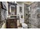 Bathroom with a unique carved vanity, ornate mirror, and glass enclosed shower at 118 Gold Piece Dr, Breckenridge, CO 80424