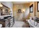 This full bathroom is equipped with a soaking tub, spacious vanity and decorative lighting at 118 Gold Piece Dr, Breckenridge, CO 80424