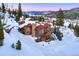 Aerial view of a beautiful mountain home surrounded by snow-covered trees at 118 Gold Piece Dr, Breckenridge, CO 80424