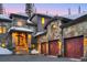 Beautiful stone house with lit stairway and multi-car garage at 118 Gold Piece Dr, Breckenridge, CO 80424