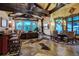 Cozy living room with stone fireplace, mountain views, and ample seating with stylish furnishings at 118 Gold Piece Dr, Breckenridge, CO 80424