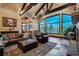 Living room features large windows, vaulted ceiling and stone fireplace at 118 Gold Piece Dr, Breckenridge, CO 80424