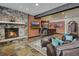 The living room has a stone fireplace, tv, wet bar and ample seating at 118 Gold Piece Dr, Breckenridge, CO 80424