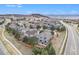 Expansive aerial view of a neighborhood with mountain views and manicured lawns on a sunny day at 2470 Robindale Way, Castle Rock, CO 80109