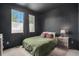 This modern bedroom features sleek black walls, bright windows, and a minimalist design at 2470 Robindale Way, Castle Rock, CO 80109
