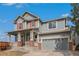 Lovely two-story home with a welcoming front porch and attached two-car garage, perfect for Gathering living at 2470 Robindale Way, Castle Rock, CO 80109
