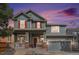 Charming two-story home with a welcoming front porch and colorful sunset backdrop at 2470 Robindale Way, Castle Rock, CO 80109