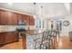 Stylish kitchen with an island featuring bar seating, stainless steel appliances, and pendant lighting at 2470 Robindale Way, Castle Rock, CO 80109