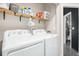 Laundry room with washer, dryer, and shelving for organization at 2470 Robindale Way, Castle Rock, CO 80109