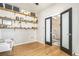 Bright office featuring hardwood floors, open shelving, and glass doors leading to the stairway at 2470 Robindale Way, Castle Rock, CO 80109