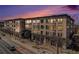 Stunning building with shops at the bottom and multiple levels of residential spaces above and beautiful sunset in the background at 277 N Broadway # 202, Denver, CO 80203