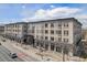Stunning building with shops at the bottom and multiple levels of residential spaces above and beautiful blue sky background at 277 N Broadway # 202, Denver, CO 80203