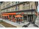 Exterior view of Snooze with a vibrant orange awning and inviting outdoor seating at 277 N Broadway # 202, Denver, CO 80203