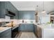Stylish kitchen featuring modern gray cabinets, stainless steel appliances, and white subway tile backsplash at 277 N Broadway # 202, Denver, CO 80203