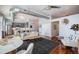 Cozy living room open to a modern kitchen with stylish furniture and a ceiling fan in an industrial design loft at 277 N Broadway # 202, Denver, CO 80203