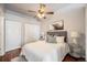 Comfortable bedroom featuring a ceiling fan, ample closet space, and charming decor and hardwood floors at 277 N Broadway # 202, Denver, CO 80203