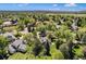Wide aerial shot of home showcasing location, a large lot and mature trees in a quiet neighborhood at 10247 W Roxbury Pl, Littleton, CO 80127