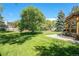 Spacious backyard with mature trees and lush green grass, great for outdoor activities at 10247 W Roxbury Pl, Littleton, CO 80127