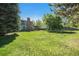 Large backyard with mature trees and a trampoline, backing up to the house at 10247 W Roxbury Pl, Littleton, CO 80127