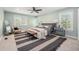 Bright bedroom with a ceiling fan, neutral decor, and natural light at 10247 W Roxbury Pl, Littleton, CO 80127