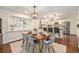 Bright dining area featuring a stylish light fixture, modern furnishings, and seamless access to the kitchen area at 10247 W Roxbury Pl, Littleton, CO 80127
