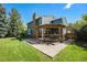A well-maintained backyard featuring a deck under a pergola with steps to the grass at 10247 W Roxbury Pl, Littleton, CO 80127
