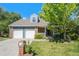 Charming two-story home featuring a well-manicured lawn, brick accents, and a two-car garage at 10247 W Roxbury Pl, Littleton, CO 80127