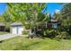 Charming two-story home featuring a well-manicured lawn, brick accents, and a two-car garage at 10247 W Roxbury Pl, Littleton, CO 80127